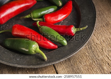 Red and green peppers in vintage moody natural lighting setting