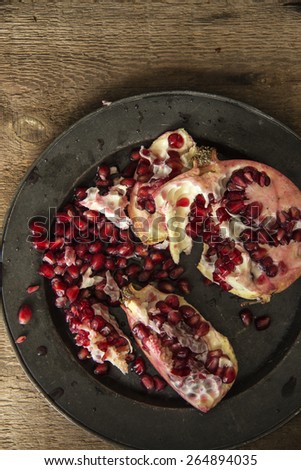 Moody natural lighting images of fresh juicy pomegranate with vintage style