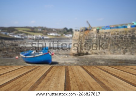 Harbor at low tide with fishing boats at Coverack England with wooden planks floor