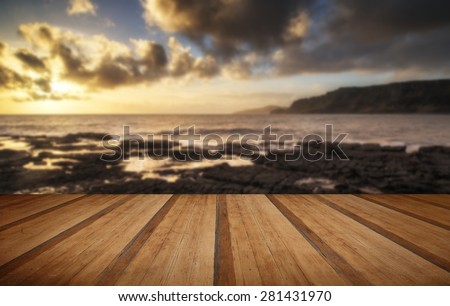 Stunning landscape ocean at sunset dramatic clouds with wooden planks floor