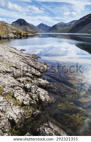 Stunning landscape of Wast Water with mountains reflected in calm lake water in Lake District
