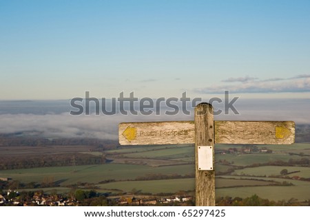 Public footpath signpost pointing in opposite direction, space for copy and text