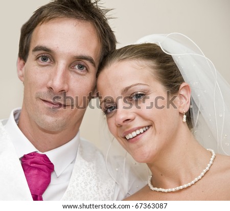 Formal portrait of smiling bridge and groom