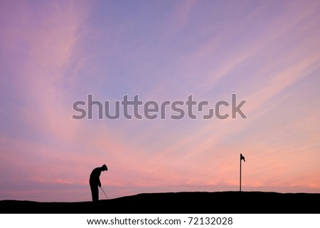 Silhouette of man playing golf on beautiful colorful sunset