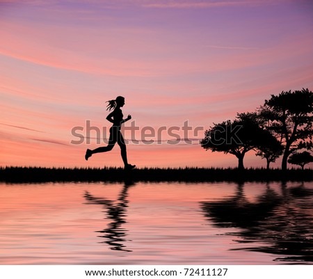 Woman jogger silhouette against beautiful sunset sky running through fields
