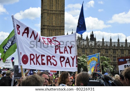 LONDON - JUNE 30; Unidentified members of trade unions display placards against the government during a demonstration  organised by PCS and NUT trade unions in London on June 30, 2011