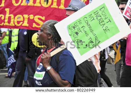 LONDON - JUNE 30; An unidentified African American woman protests against government proposed pension reform during a march organised by unions in London on June 30, 2011