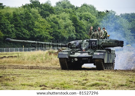 LONDON - JULY 21 - Unidentified members of the public drive modern era tank during War and Peace Show, largest military sohw in the world, on July 21st, 2011 near London, England