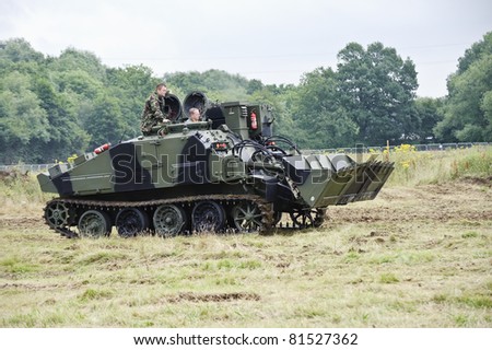 LONDON - JULY 21 - Unidentified members of the public drive modern era armoured vehicle at War and Peace Show, world\'s largest military show, on July 21st, 2011 near London, England