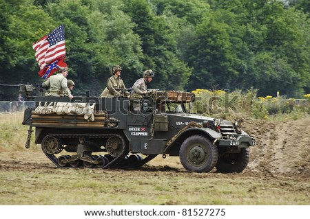 LONDON - JULY 21 - Unidentified members of the public drive WW2 era American military half track during War and Peace, world\'s largest military show, on July 21st, 2011 near London, England