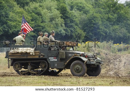 LONDON - JULY 21 - Unidentified members of the public drive WW2 era American military half track during War and Peace, world\'s largest military show, on July 21st, 2011 near London, England