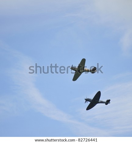 EASTBOURNE, ENGLAND - AUGUST 12 - World War Two British Hurricane and Sptifire together in flight at annual International Airshow on 12th August 2011 at Eastbourne in England