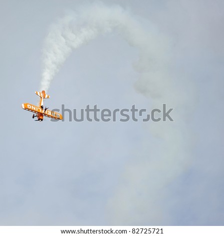 EASTBOURNE, ENGLAND - AUGUST 12 - Breitling Wingwalkers daredevil display team performs high dive in flight at annual International Airshow on 12th August 2011 at Eastbourne in England