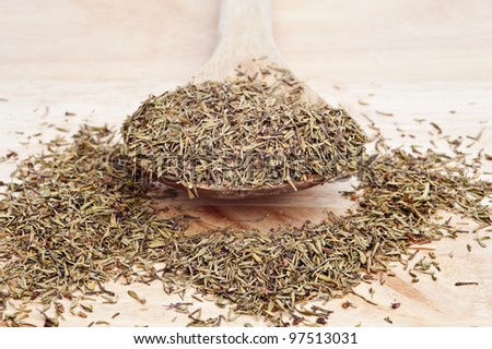 Thyme herb on wooden serving spoon with shallow depth of field