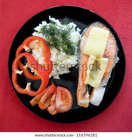 Trout baked with cheese, rice and vegetables