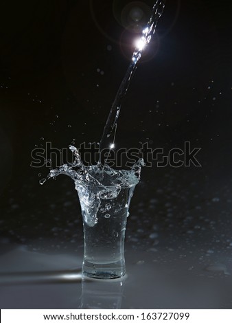 Vodka glass with splashes