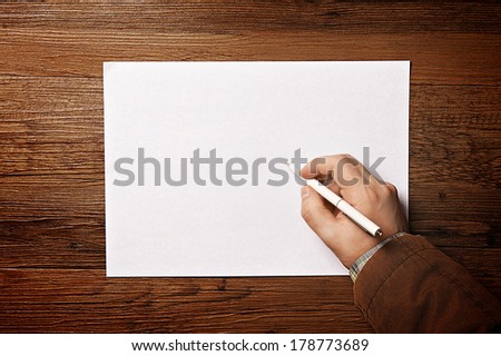 Man writing on paper. Top view.