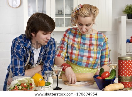 Portrait of a happy young couple preparing meat dumplings