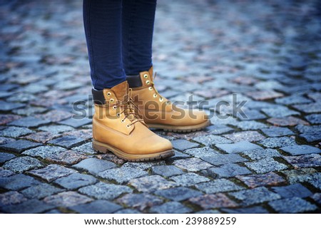 Close-up of woman feet in yellow boots