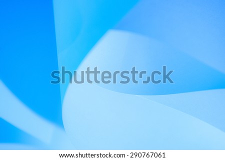 Abstract twisted sheets of blue paper. backround.