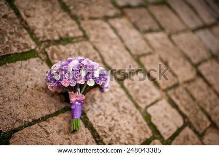 Purple wedding bouquet on the wall of an old building in Montenegro