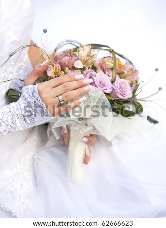 stock photo Hands and rings on wedding bouquet