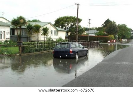 Automobile caught in storm-water drain overflow