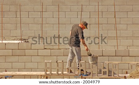 Bricklayer laying concrete blocks