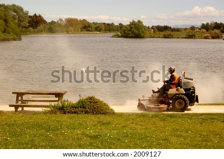 mowing grass at the lakeside
