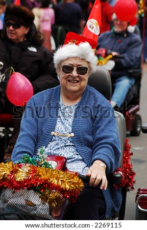 senior lady on mobility scooter in xmas parade