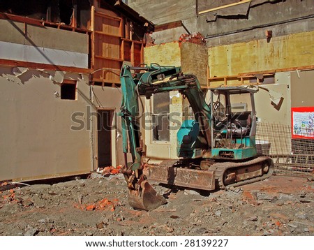 Digger at small construction site in city