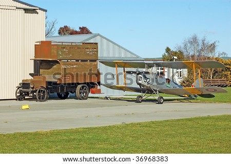 two modes of vintage transportation-a 1914-18 british army bus and a between wars biplane
