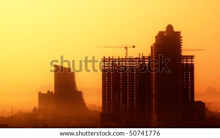 Skyscrapers in vibrant colors. Building on the sunset.