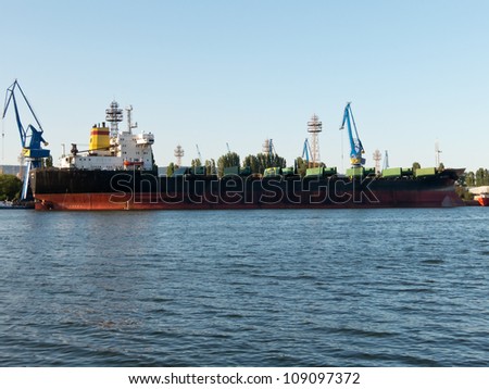 VARNA, BULGARIA - JULY 21: Bulk carrier BALTIC STAR, Flag: Bulgaria, Year Built: 1985, is loaded with goods on July 21, 2012 in Varna, Bulgaria.