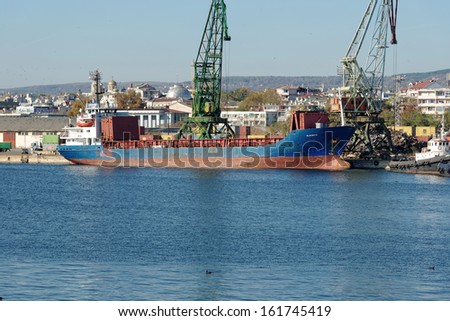 VARNA, BULGARIA - OCT 27: Cargo ship Blue Sky S (IMO: 7601073, Year Built: 1977, Flag: Moldova) is loaded with 2000 t of scrap metal in Port of Varna-East on October 27, 2013 in Varna, Bulgaria.