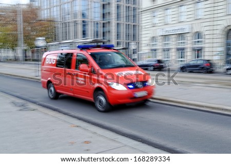VIENNA - NOV 23. A fire rescue vehicle blazes by, it\'s sirens whaling in Vienna, Austria on November 23, 2013. An intentional motion blur gives a feeling of a rushed tension to the scene.