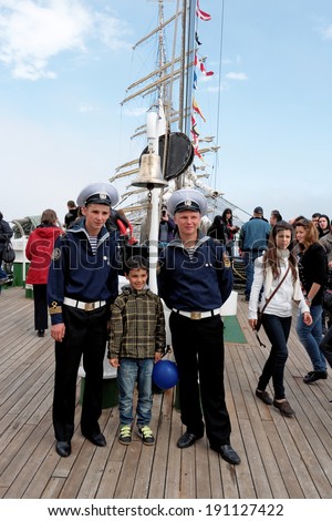 VARNA, BULGARIA - MAY 01, 2014: Varna is a host of the maritime event - SCF Black Sea Tall Ships Regatta. Russian sailors from tall ship Nadezhda are posing for pictures with visitors.