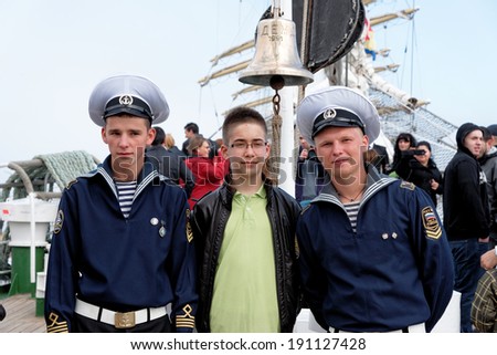 VARNA, BULGARIA - MAY 01, 2014: Varna is a host of the maritime event - SCF Black Sea Tall Ships Regatta. Russian sailors from tall ship Nadezhda are posing for pictures with visitors.