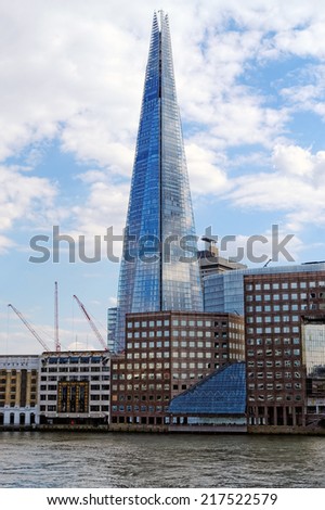 LONDON, UK - JULY 1, 2014: Shard of glass on the river Thames, office and residential building in the City of London one of the leading center of global finance.