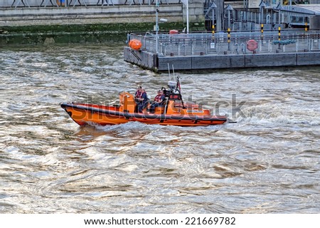 LONDON, ENGLAND - JULY 1, 2014: The London Life Rescue boat is speeding along the Thames River.