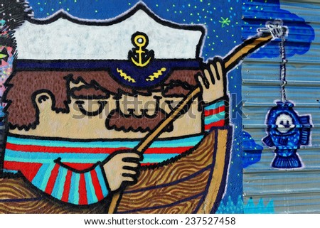 Varna, BULGARIA - December 14, 2014: Street art by unknown artist of a captain holding a fishing rod close to Port of Varna.