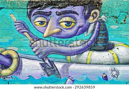 Varna, BULGARIA - June 21, 2015: Street art by unknown artist on a concrete wall close to Port of Varna of a sailor with a lifebelt on, holding an oar.