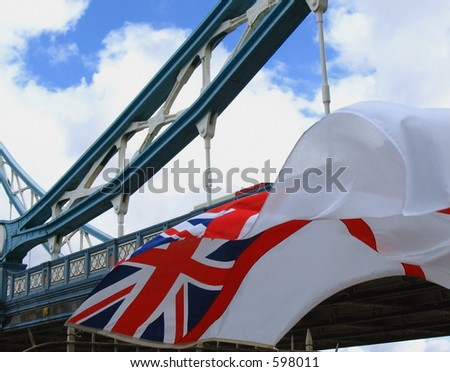 Queen\'s colours of the British Royal Navy flying close to Tower Bridge, London