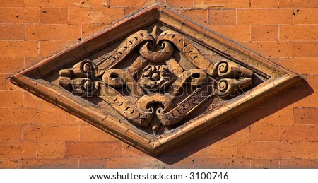 Ornamental medieval house decoration in orange. London, United Kingdom.