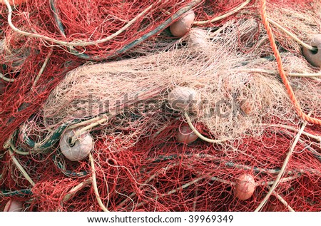 Detail of fishing nets stacked in a heap on the quayside - useful background or texture