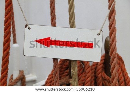 Direction sign shot on a tall ship with visible rain drops on.