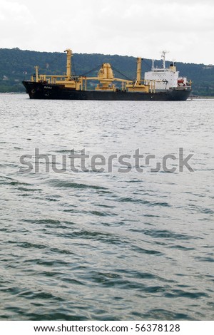 VARNA, BULGARIA - JULY 01: Cargo ship MANA (Year Built: 1978, Flag: Panama, DeadWeight: 17089 t) is sailing away into open sea after a short stay in Port of Varna on July 01, 2010 in Varna, Bulgaria.