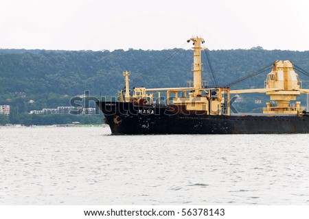 VARNA, BULGARIA - JULY 01: Cargo ship MANA (Year Built: 1978, Flag: Panama, DeadWeight: 17089 t) is sailing away into open sea after a short stay in Port of Varna on July 01, 2010 in Varna, Bulgaria.