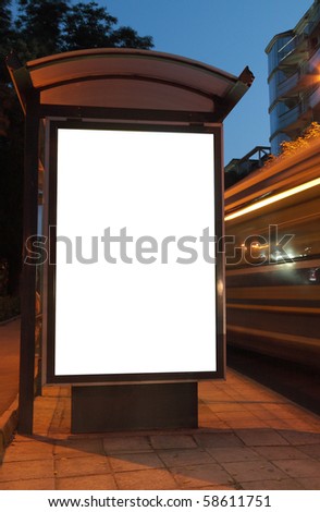 Bus stop at night. Blurred light from the passing vehicles are visible. This is for advertisers to place ad copy samples on a bus shelter.