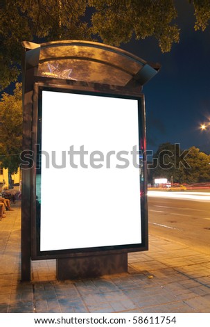 Bus stop at night. Blurred light from the passing vehicles are visible. This is for advertisers to place ad copy samples on a bus shelter.